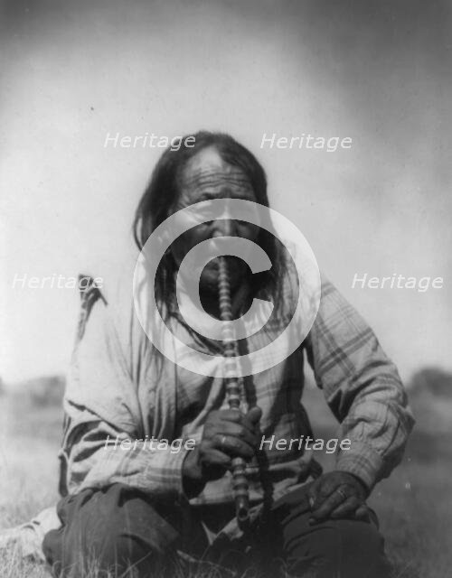 Arapaho Indian smoking pipe, c1910. Creator: Edward Sheriff Curtis.