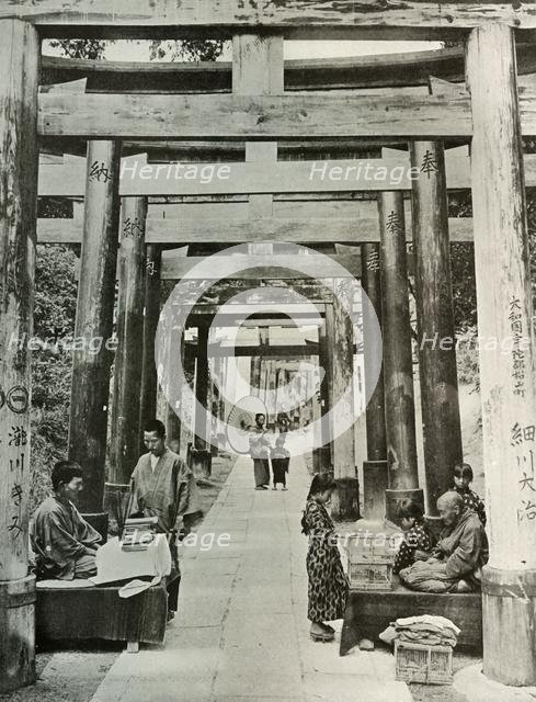 'An Avenue of Torii at Inari', 1910. Creator: Herbert Ponting.