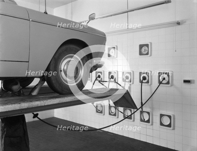 A traditional lubrication bay and mechanic at a garage, Sheffield, South Yorkshire, 1965. Artist: Michael Walters