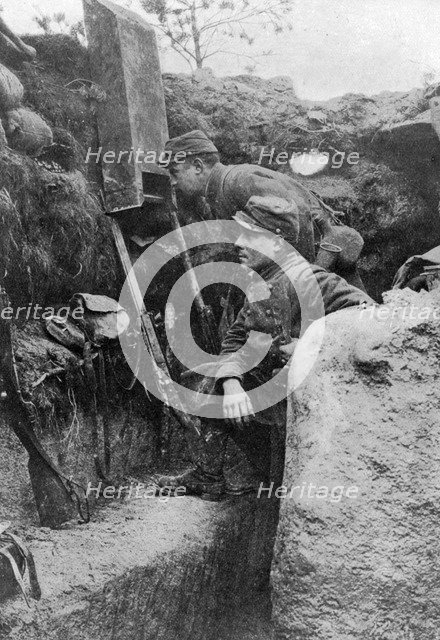 The periscope in use in a French trench, First World War, 1914-1918, (c1920). Artist: Sphere