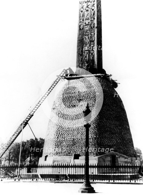 Sandbags protecting the base of the Egyptian obelisk, German-occupied Paris, 1940. Artist: Unknown
