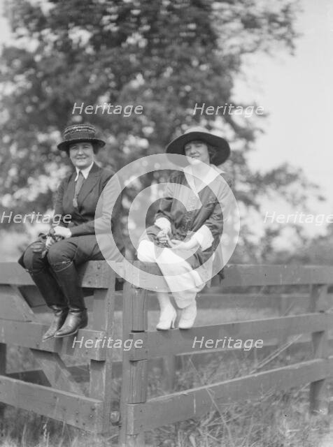 Bruce, Mrs., and Miss Hedman, seated outdoors on a fence, 1919 May 30. Creator: Arnold Genthe.