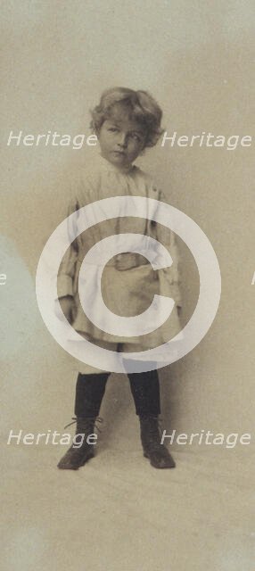 Portrait of a young boy standing in short pants and belted shirt, c1900. Creator: Misses Selby.