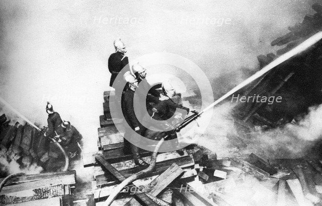 Firemen fighting a fire at a timber yard, London, 1926-1927. Artist: Unknown