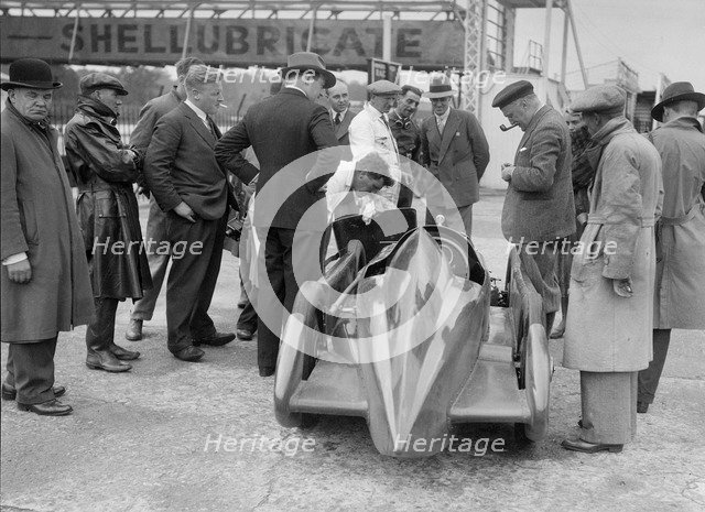 People examining Leon Cushman's Austin 7 racer at Brooklands for a speed record attempt, 1931. Artist: Bill Brunell.