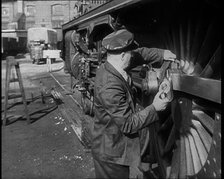 A Man Doing Maintenance Work on a Train Carriage, 1940. Creator: British Pathe Ltd.