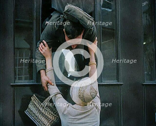Male Soldier Kissing Female Civilian from the Window of a Train, 1929. Creator: British Pathe Ltd.
