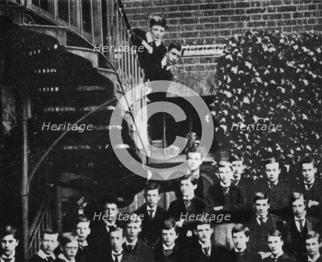 'Winston climbing a staircase, while the class pose', c1889, (1945). Artist: Unknown.