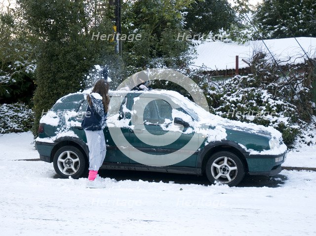 Girls palying with snowballs by VW Golf 2009 Artist: Unknown.