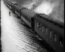 Train Driving Through Flooded Fields and Tracks, 1926. Creator: British Pathe Ltd.