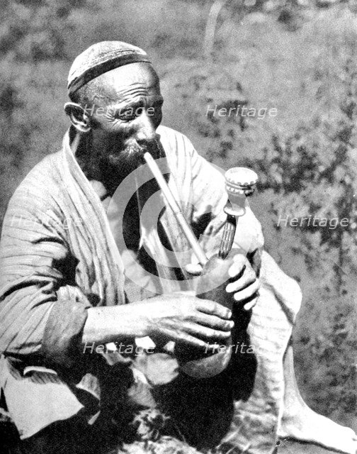 Uzbek man smoking calian, Samarkand, 1936. Artist: Unknown