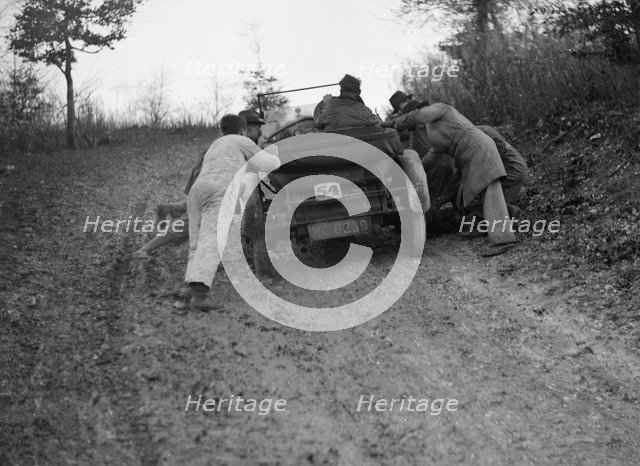 EA Beale's Vauxhall 30-98 Velox 4 seater receiving a push during the Inter-Varsity Trial, 1930. Artist: Bill Brunell.