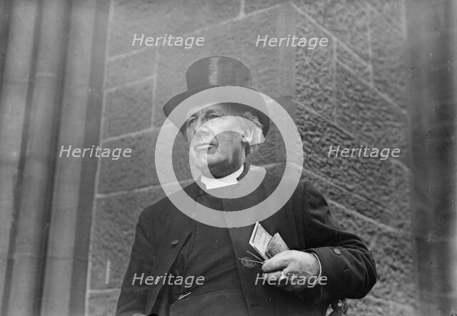 Bishop of Salisbury holding glasses and train schedule, 1910. Creator: Bain News Service.