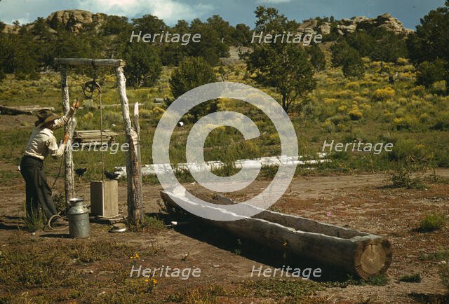 Faro Caudill drawing water from his well, Pie Town, New Mexico, 1940. Creator: Russell Lee.