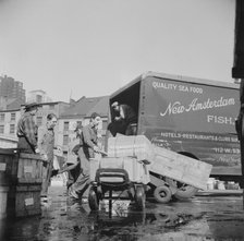 Loading boxes of fish to be shipped to hotels and restaurants at the Fulton fish..., New York, 1943. Creator: Gordon Parks.