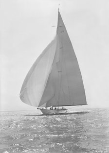 The 23 Metre 'Candida' (K8) sailing with spinnaker, 1935. Creator: Kirk & Sons of Cowes.
