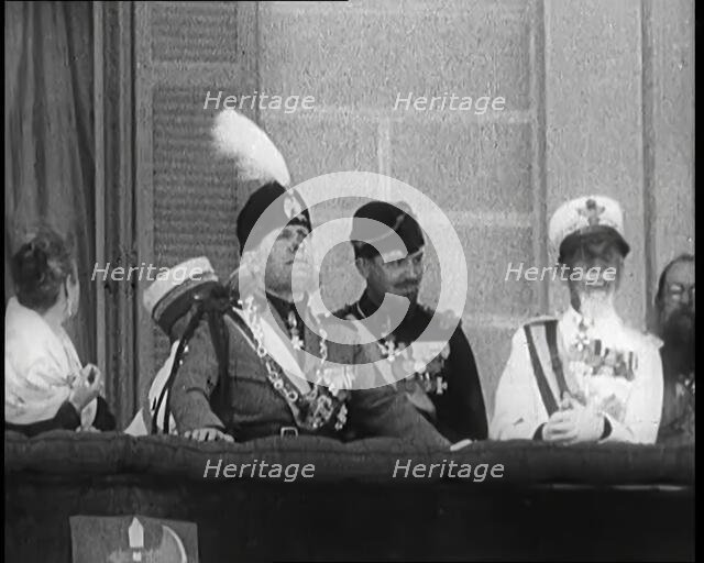 Benito Mussolini Reviewing Troops from a Balcony. Mussolini's Nose is Injured from an..., 1926. Creator: British Pathe Ltd.
