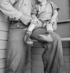 Baby with club feet wearing homemade splints, FSA camp, Tulare County, California, 1939. Creator: Dorothea Lange.
