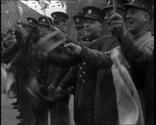 Uniformed British Soldiers Cheering and Smiling Whilst Waving Flags, 1937. Creator: British Pathe Ltd.