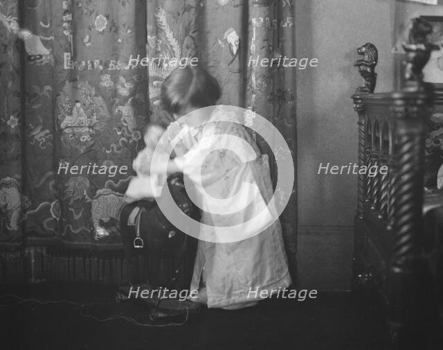 Rice, Isaac, Mrs., grandaughter of, playing with a doll, 1920 May 27. Creator: Arnold Genthe.
