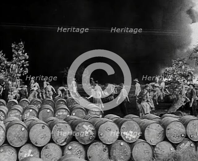 Commonwealth Troops Walking Through a Flaming Supply Dump, 1941. Creator: British Pathe Ltd.