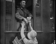 Male Soldier Kissing Female Civilian from the Window of a Train, 1929. Creator: British Pathe Ltd.