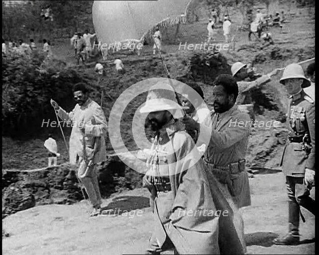 Haile Selassie I, Emperor of Ethiopia Walking with a Crowd, 1930s. Creator: British Pathe Ltd.