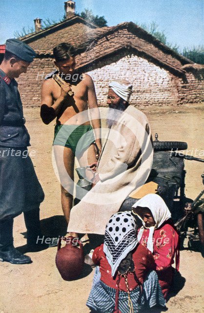 Yugoslavian pilots talking to a local, 1941. Artist: Unknown