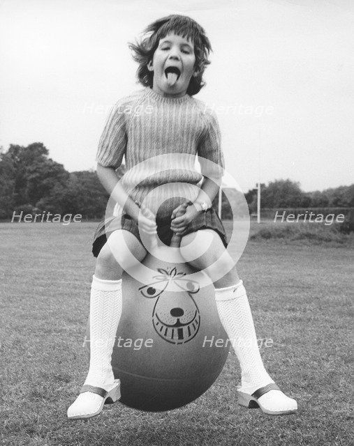 Girl on a space hopper, 1970s.