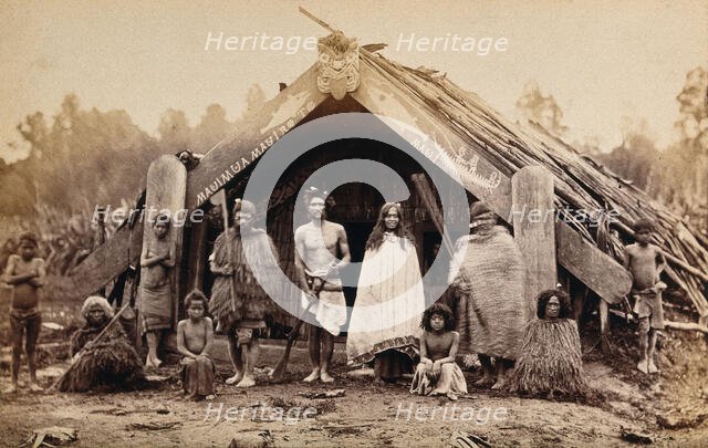 New Zealand: a group of Maori in front of a traditional building, 19th century. Creator: Unknown.