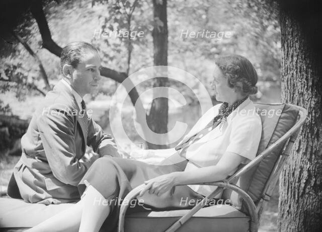 Mrs. Mary Benson and unidentified man, seated outdoors, 1933. Creator: Arnold Genthe.
