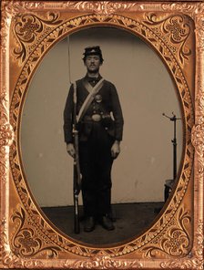 [Union Soldier Holding Rifle, with Photographer's Posing Stand], 1861-65. Creator: Unknown.