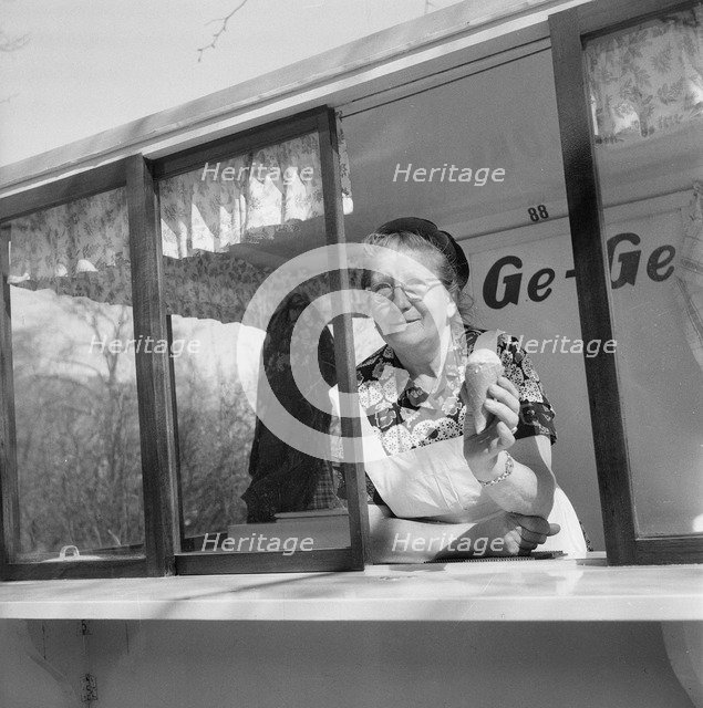 The first ice cream of the year; woman in her ice cream stall, Landskrona, Sweden, 1953. Artist: Unknown