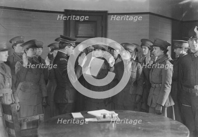 Colonel J.H. Wells swearing in woman motorist, 29 May 1917. Creator: Bain News Service.