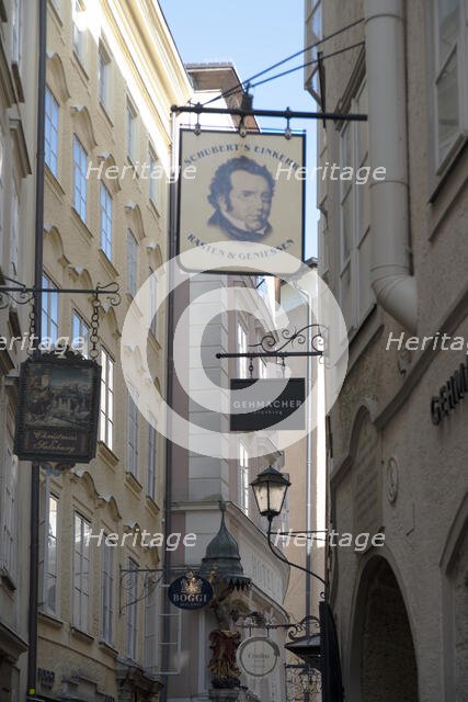 Detail view of the traditional signs along an old building on Getreidegasse, Salzburg, Austria, 2022 Creator: Ethel Davies.