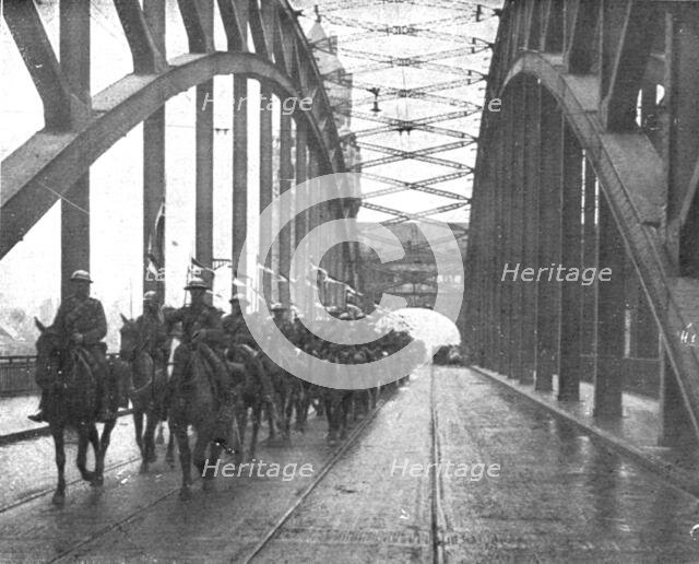 'Les Anglais sur le Rhin; A Cologne, Lanciers britanniques passant le Rhin a Cologne..., 1918. Creator: Jean Clair-Guyot.