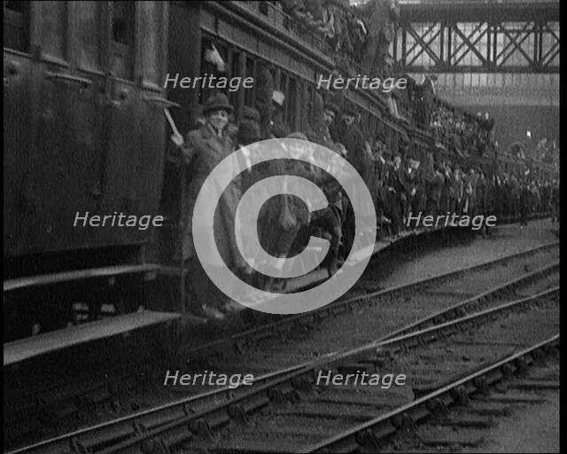 French People Hanging Onto the Outside of a Packed Train as It Drives Along, 1920. Creator: British Pathe Ltd.
