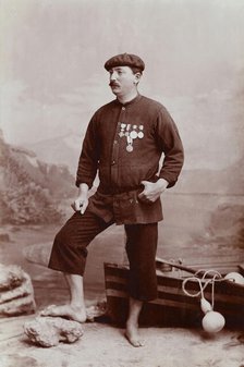 A barefoot Basque fisherman posing with several medals on his tunic, undated, estimated c1900s. Creator: Unknown.