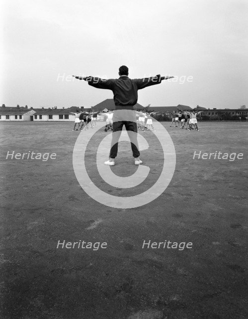 Games master taking a gym class, Airedale school, Castleford, West Yorkshire, 1962. Artist: Michael Walters