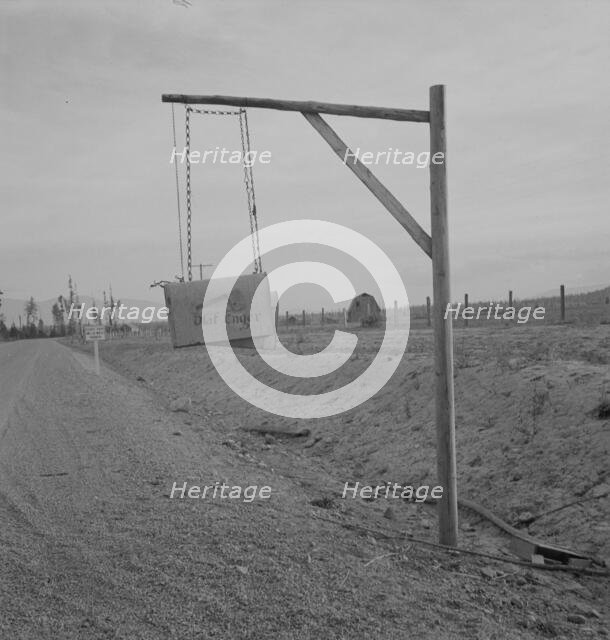 Swinging mail boxes in country where snow is deep in winter, Boundary County, Idaho, 1939. Creator: Dorothea Lange.