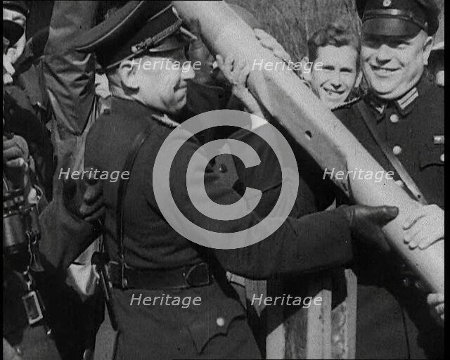 Male German Officers Removing a Barrier at a Checkpoint on the Border Between Germany and..., 1938. Creator: British Pathe Ltd.