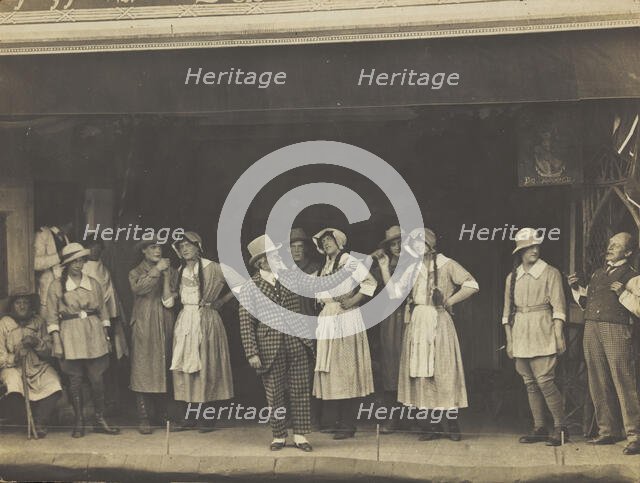 Sailors, some in drag, stand on stage performing a scene, (between 1910 and 1919?). Creator: Unknown.