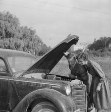 Checking the engine under the bonnet of an Opel Olympia, Landskrona, Sweden, 1959. Artist: Unknown