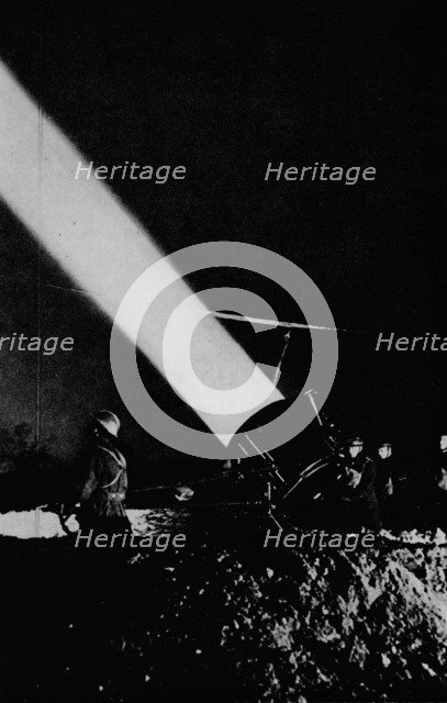 Elephant's child. A searchlight of 210,000,000 candle-power probes the night sky with its beam, 1 Artist: Unknown.