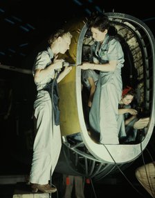 Riveters at work on fuselage of Liberator..., Consolidated Aircraft Corp., Fort Worth, Texas, 1942. Creator: Howard Hollem.