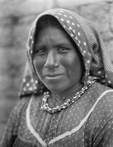 Yaqui matron, head-and-shoulders portrait, facing slightly left, wearing printed cotton..., c1907. Creator: Edward Sheriff Curtis.
