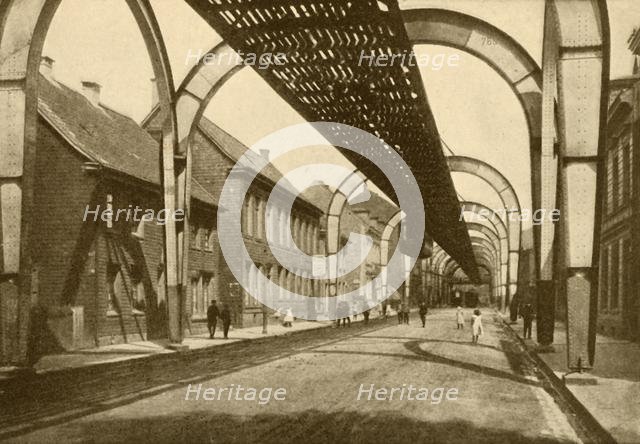 'An Electric Suspension Mono-Rail System', 1930. Creator: ENA.