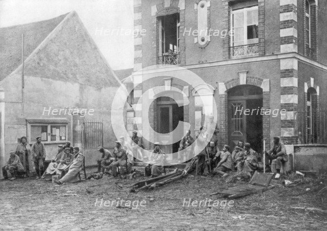 German troops sitting on the steps of the Vareddes Town Hall, France, 1914. Artist: Unknown