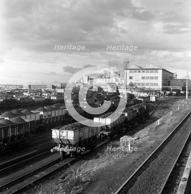 Rail trucks loaded with coal leaving Lynemouth Colliery, Northumberland, 1963.  Artist: Michael Walters