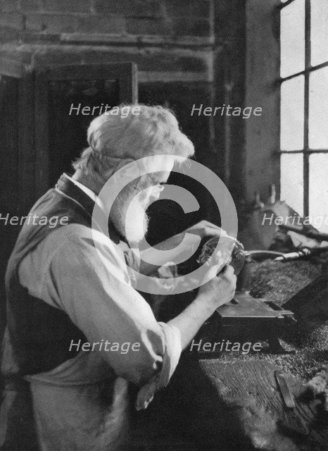 A watch cap maker at work, 1911-1912.Artist: AL Hitchin
